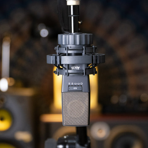 AKG 414 mic upside down on a stand with no cover