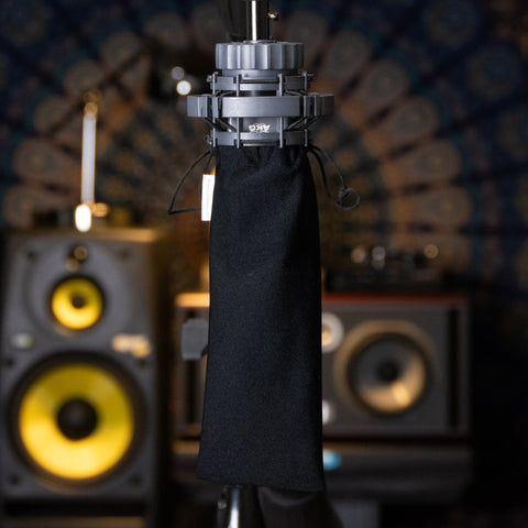 AKG 414 mic upside down on a stand with synthetic dust free medium-large cover